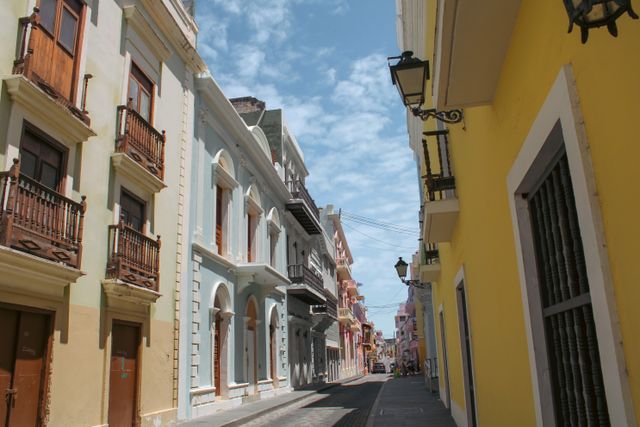 Colorful historic buildings lining a vibrant street in Old San Juan, Puerto Rico on a sunny day.