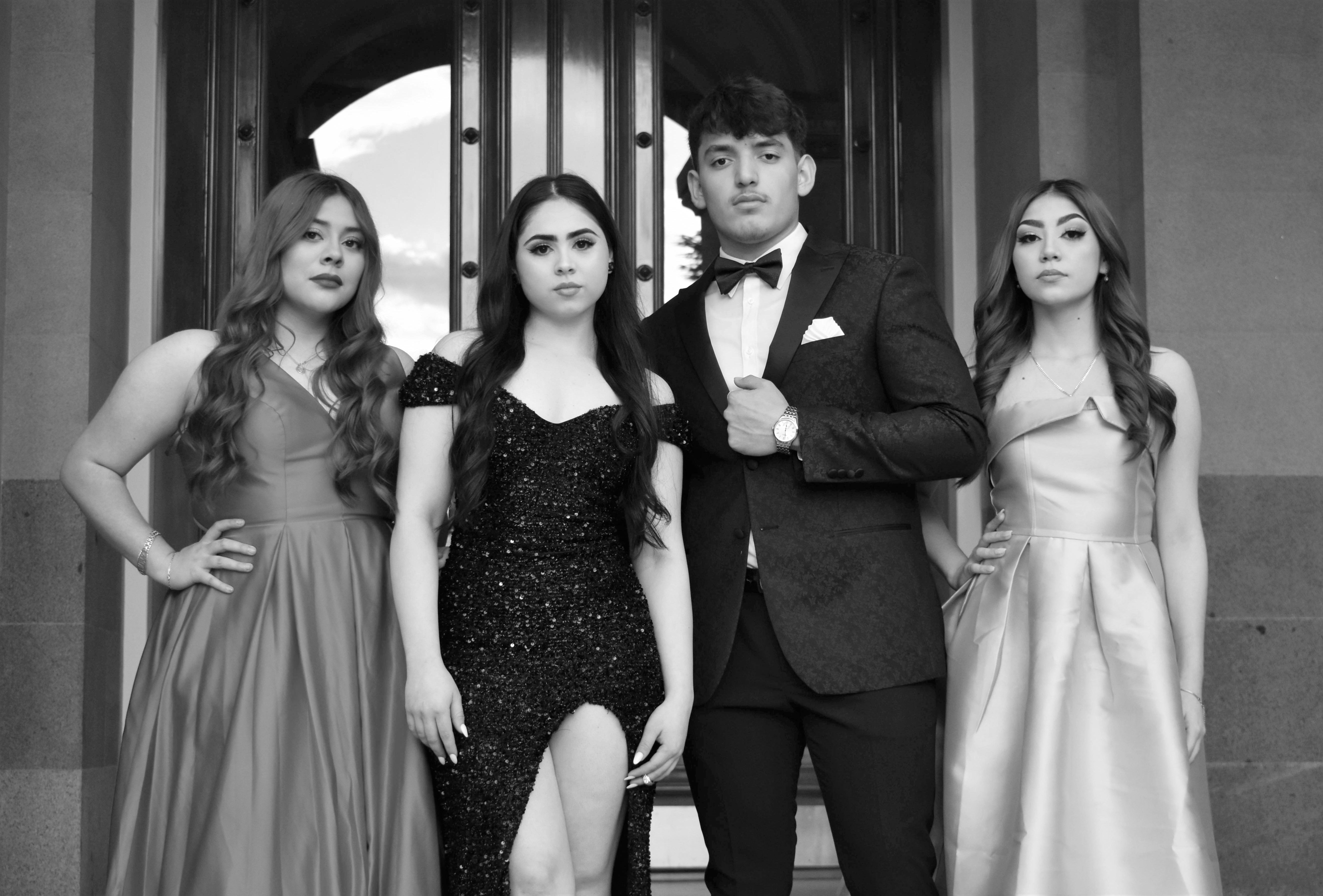 Young people dressed in formal wear for a prom or formal evening event
