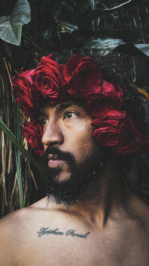 Man Posing in Red Roses Wreath