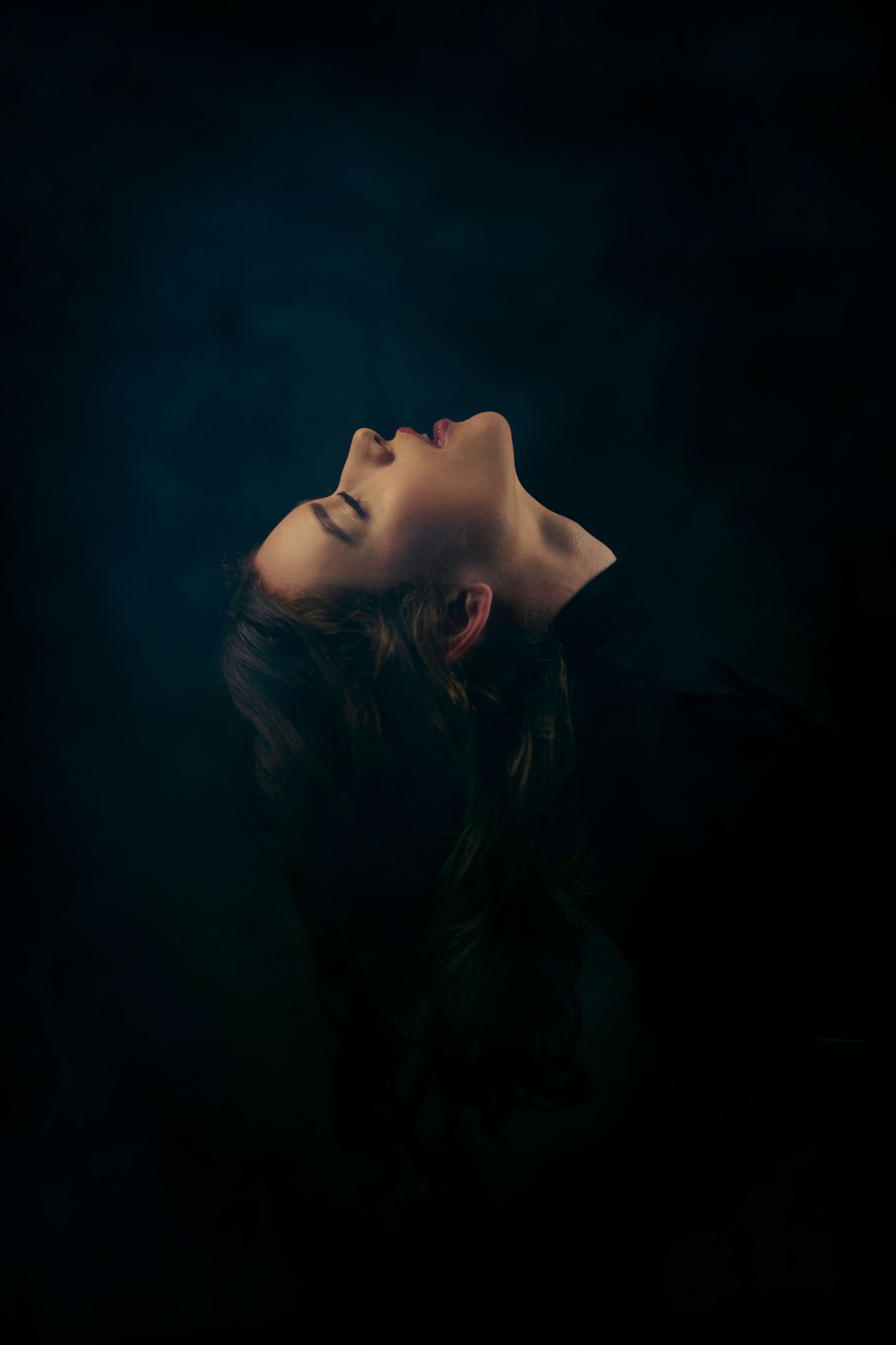 Woman Posing with Eyes Closed in Darkness · Free Stock Photo