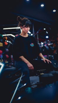 A young woman sitting and resting after a workout session in a modern gym setting.
