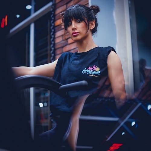 A woman in a black shirt riding a bike