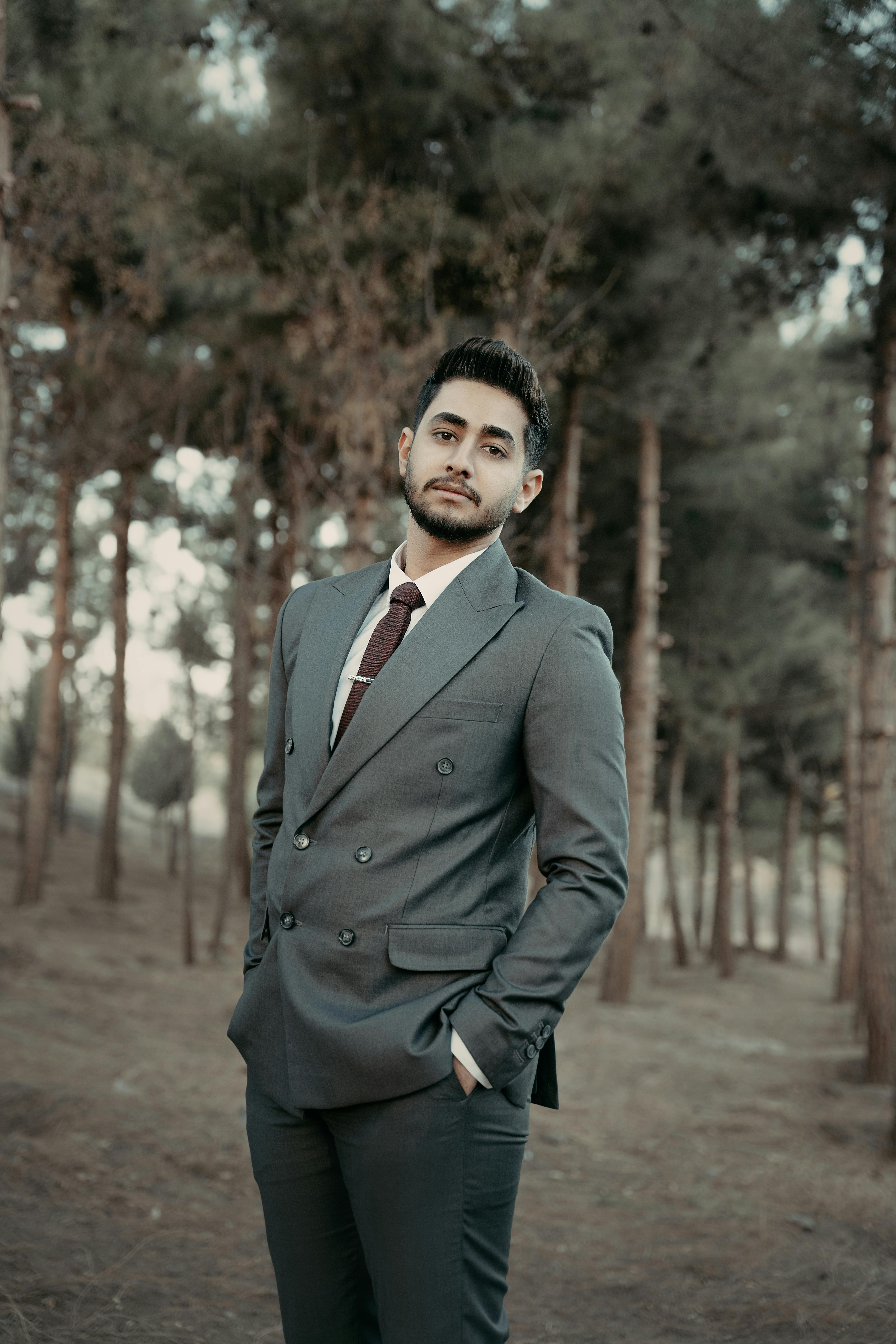 Stylish Man in Suit and Sunglasses Posing in Park · Free Stock Photo