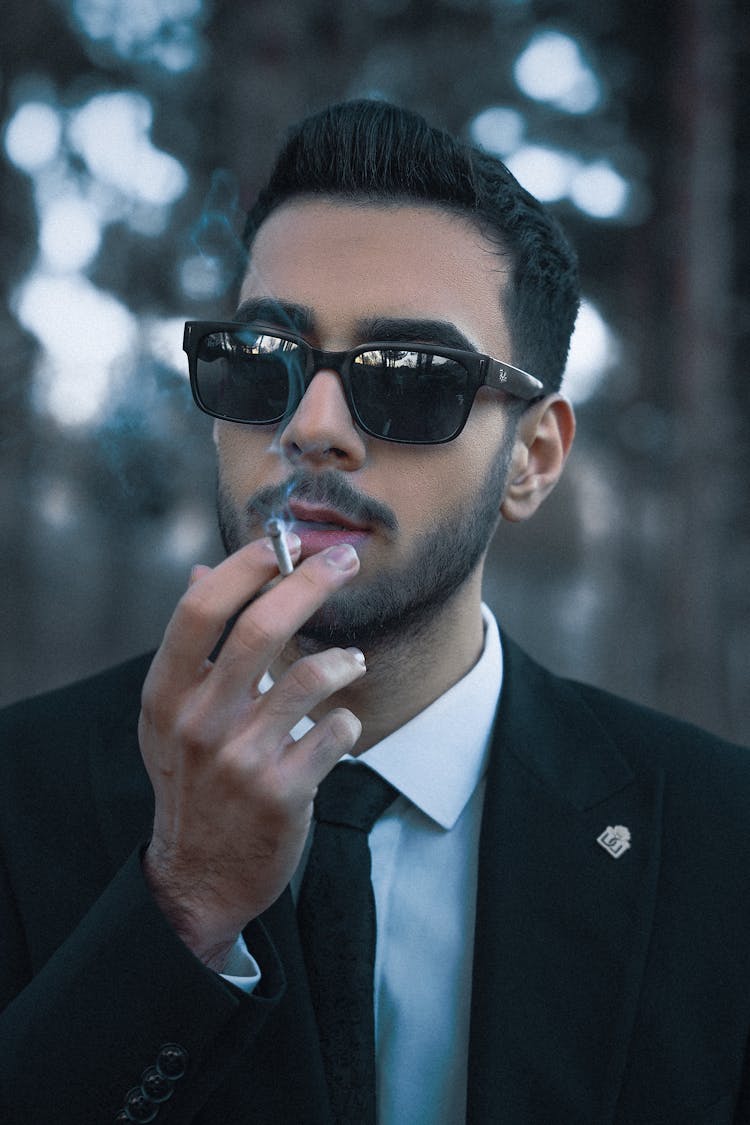 Man Wearing Suit And Sunglasses Smoking Cigarette