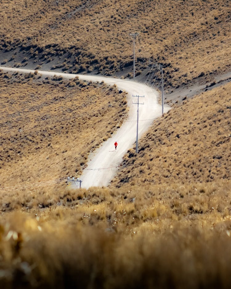 Person Walking On Road In Mountains Countryside