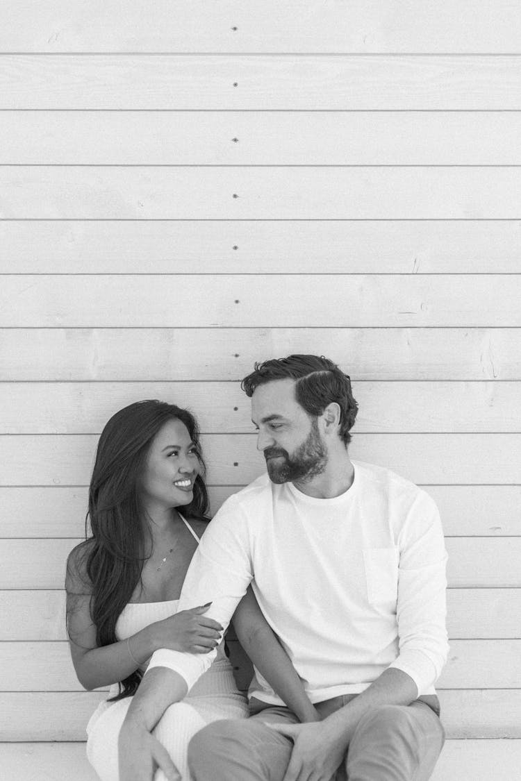 Smiling Couple Sitting Together In Black And White