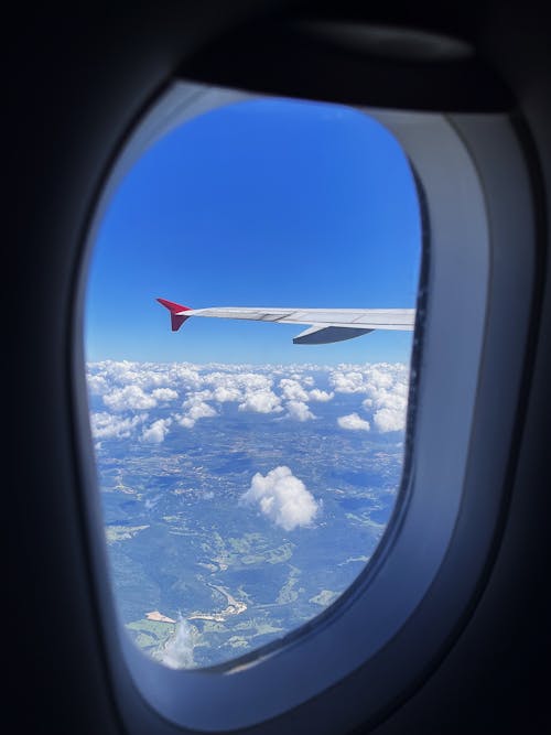 Clouds behind Airplane Window