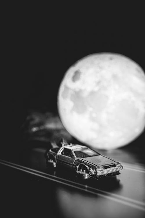 Toy Car DeLorean from Back to the Future on the Shelf Next to the Full Moon Lamp
