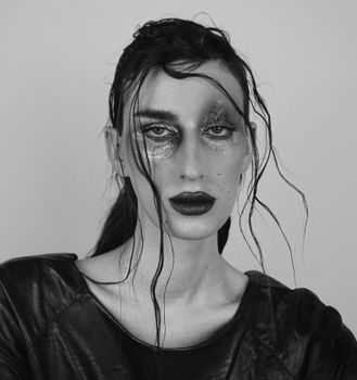 Elegant black and white portrait featuring dramatic makeup and wet hair look in Greece.