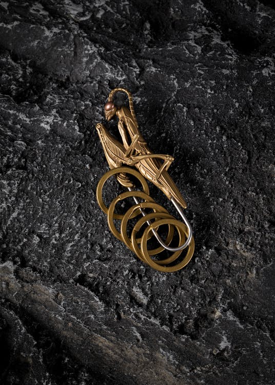 Brass Praying Mantis Clip with Keychains Lying on the Stone · Free ...