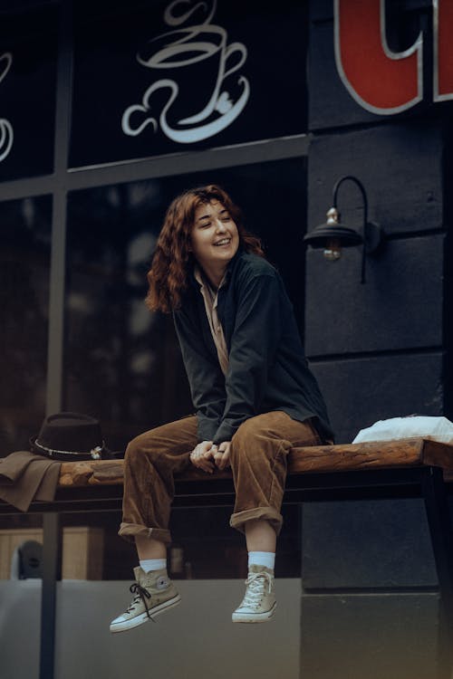 Smiling Woman on High Urban Bench