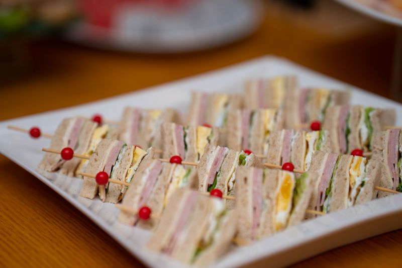 platter of sliced meats, cheeses, and bread