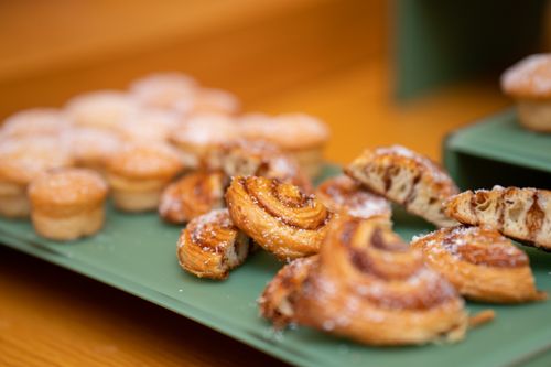 Free Close-up of a variety of pastries on a green tray with selective focus. Stock Photo