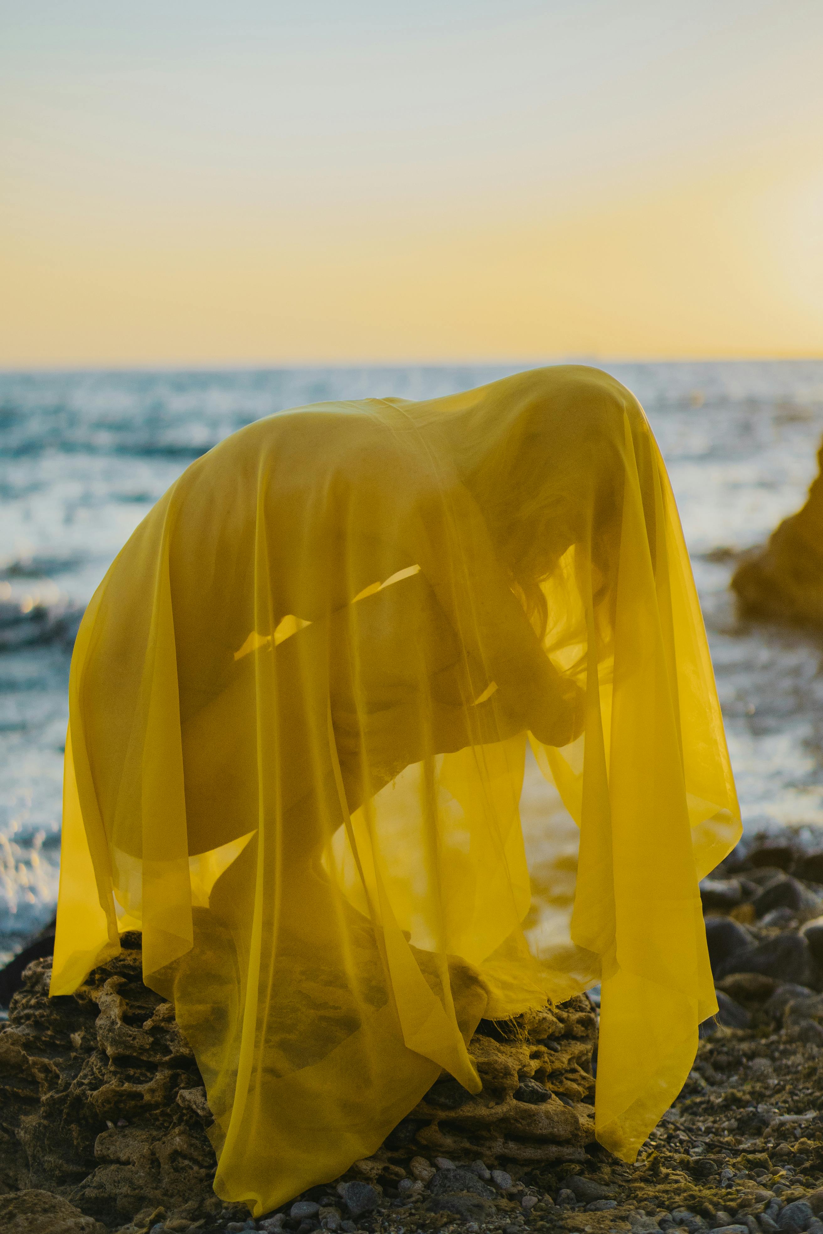 Naked Woman in Fabric Sitting on Beach on Sunset · Free Stock Photo