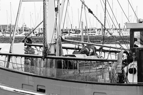 Free A detailed black and white image of a fishing trawler at Norddeich harbor, Germany. Stock Photo