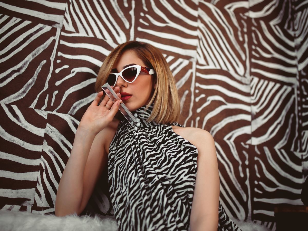 A glamorous woman in animal print and sunglasses — wearing leopard with conviction
