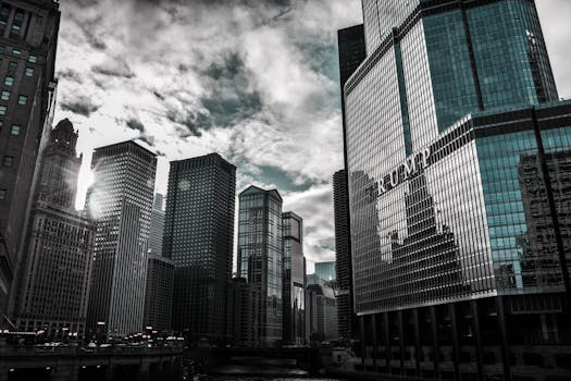 Chicago cityscape featuring Trump Tower with dramatic reflections against a cloudy sky.