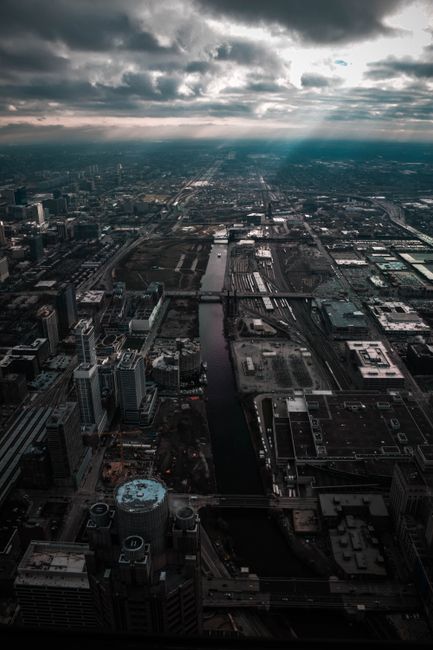 A captivating aerial shot of a sprawling cityscape under a dramatic sky. Perfect for urban and architectural themes.
