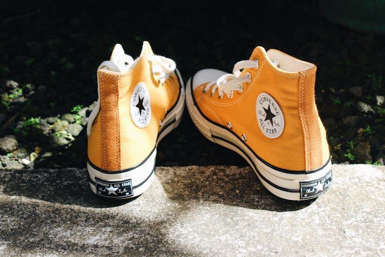 A Pair Of Orange Converse Shoes 