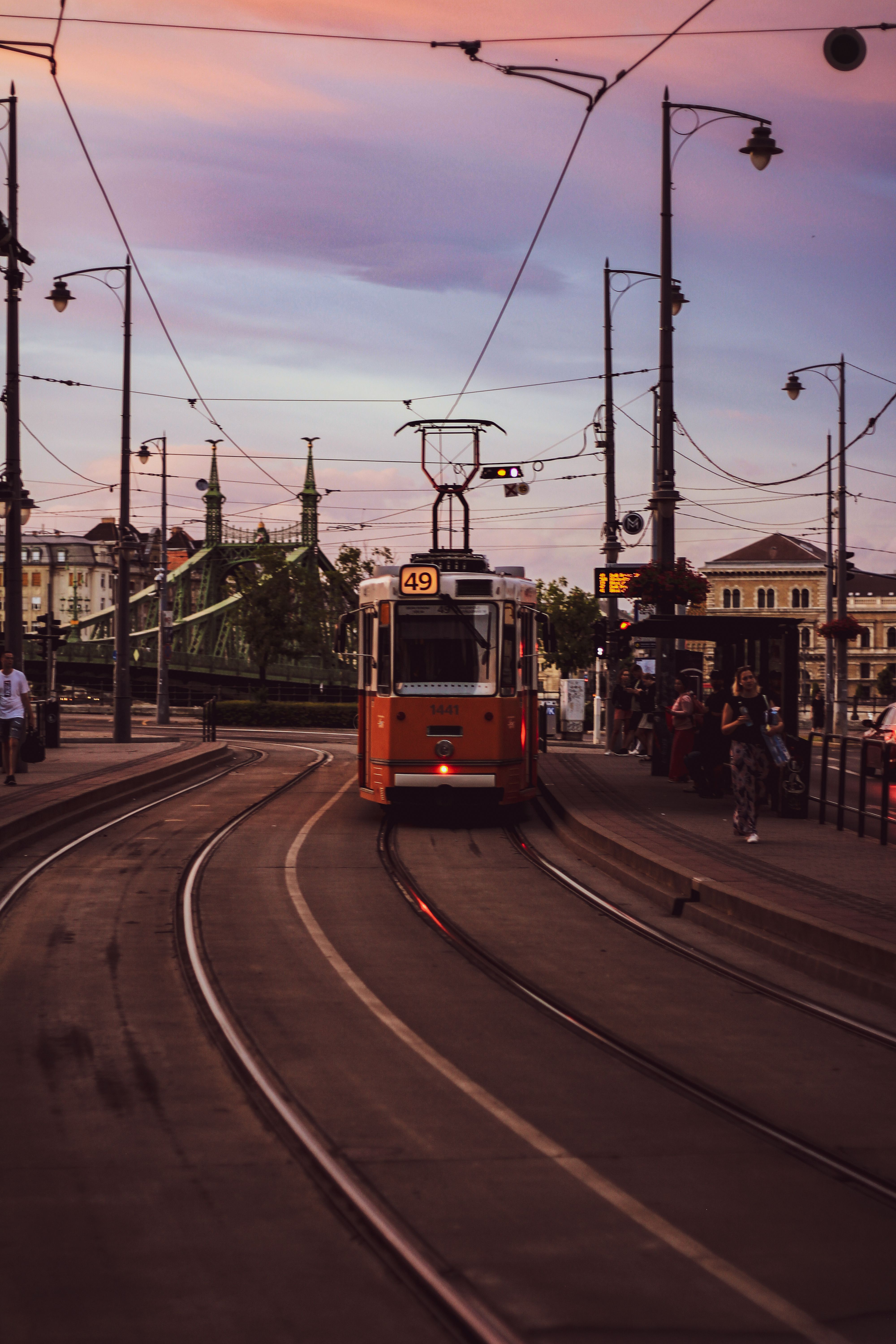 Red Tram on a Street During Sunset · Free Stock Photo