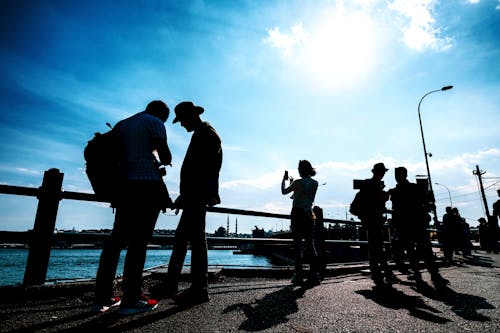 Silhouettes of People on a Pier 