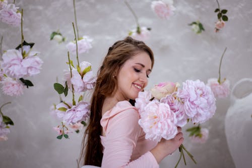 Smiling Woman Posing with Purple Flowers