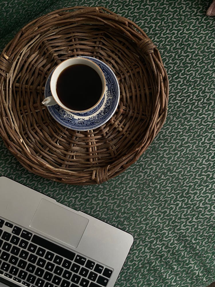 Coffee In Cup In Basket Near Laptop