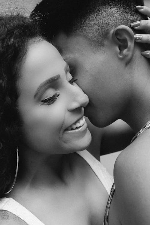 Woman's Left Hand on Person's Back of Head