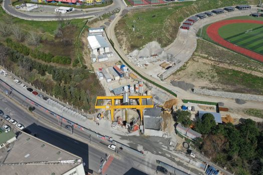 Sunlit aerial view of a construction site in Güngören, İstanbul near a stadium.