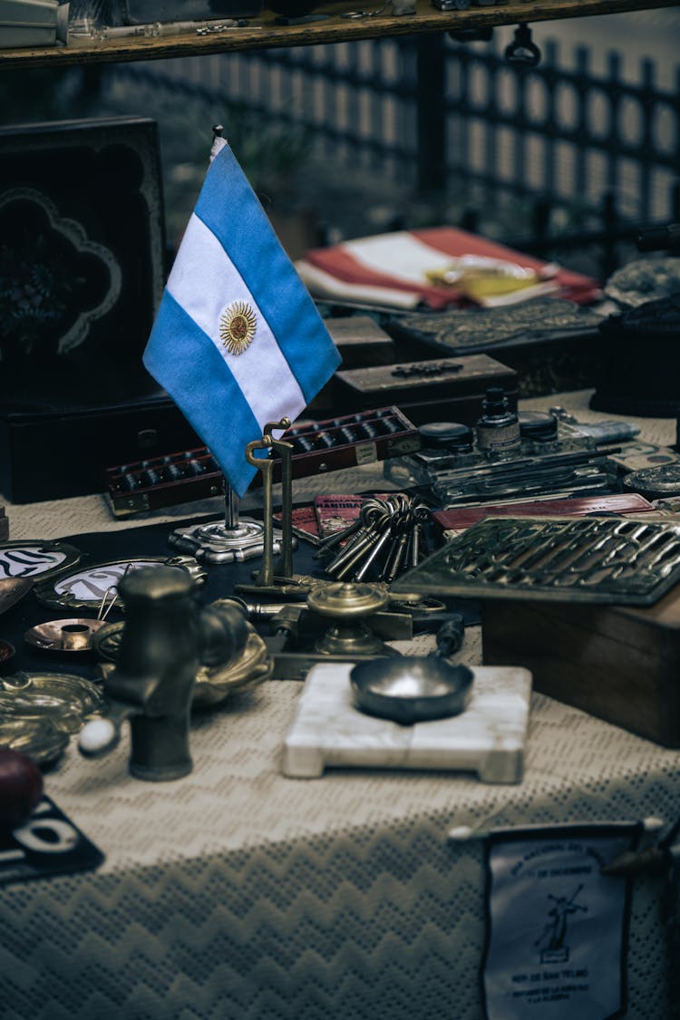 Argentinian Flag On Messy Table With Tools And Accessories