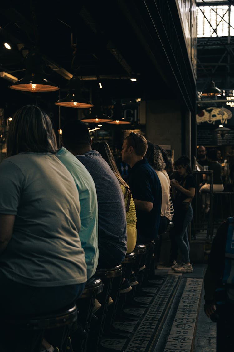 People Sitting At The Bar Counter 