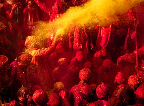 Free Colorful Holi celebration with people enjoying vibrant powder in Vrindavan, India. Stock Photo
