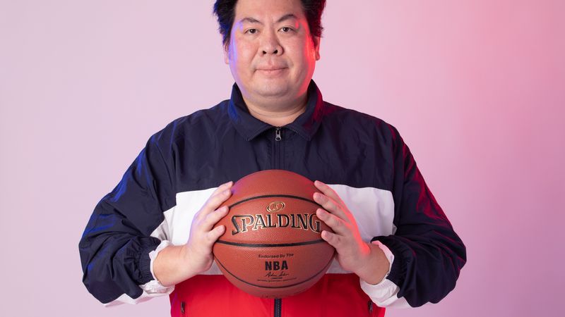 Man in sportswear with basketball against a gradient background.