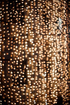 Glowing golden bokeh lights create a festive and abstract background.
