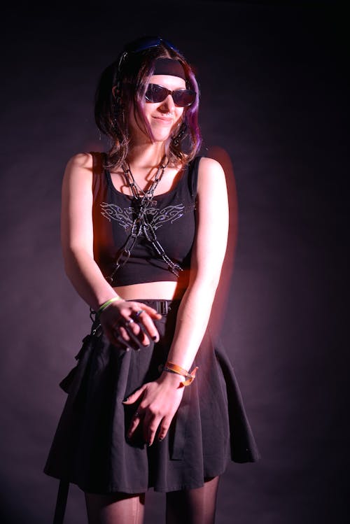 Brunette Woman in Black Top and Skirt with Chain on Torso