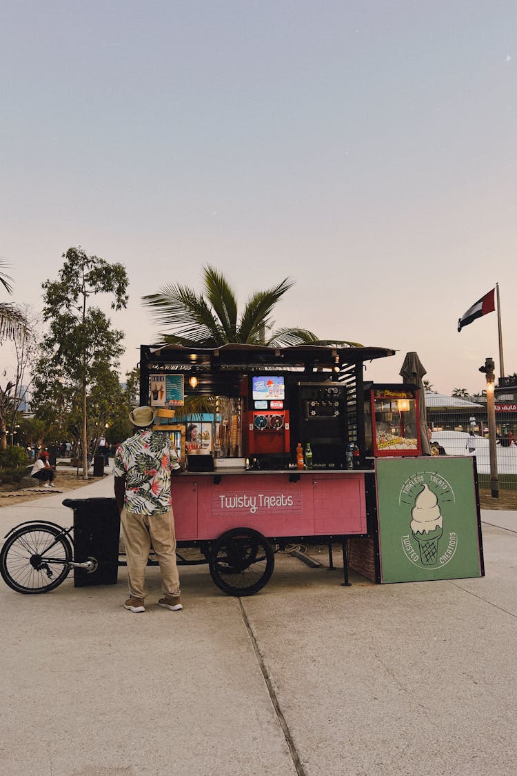 Man Standing By Mobile Food Stand