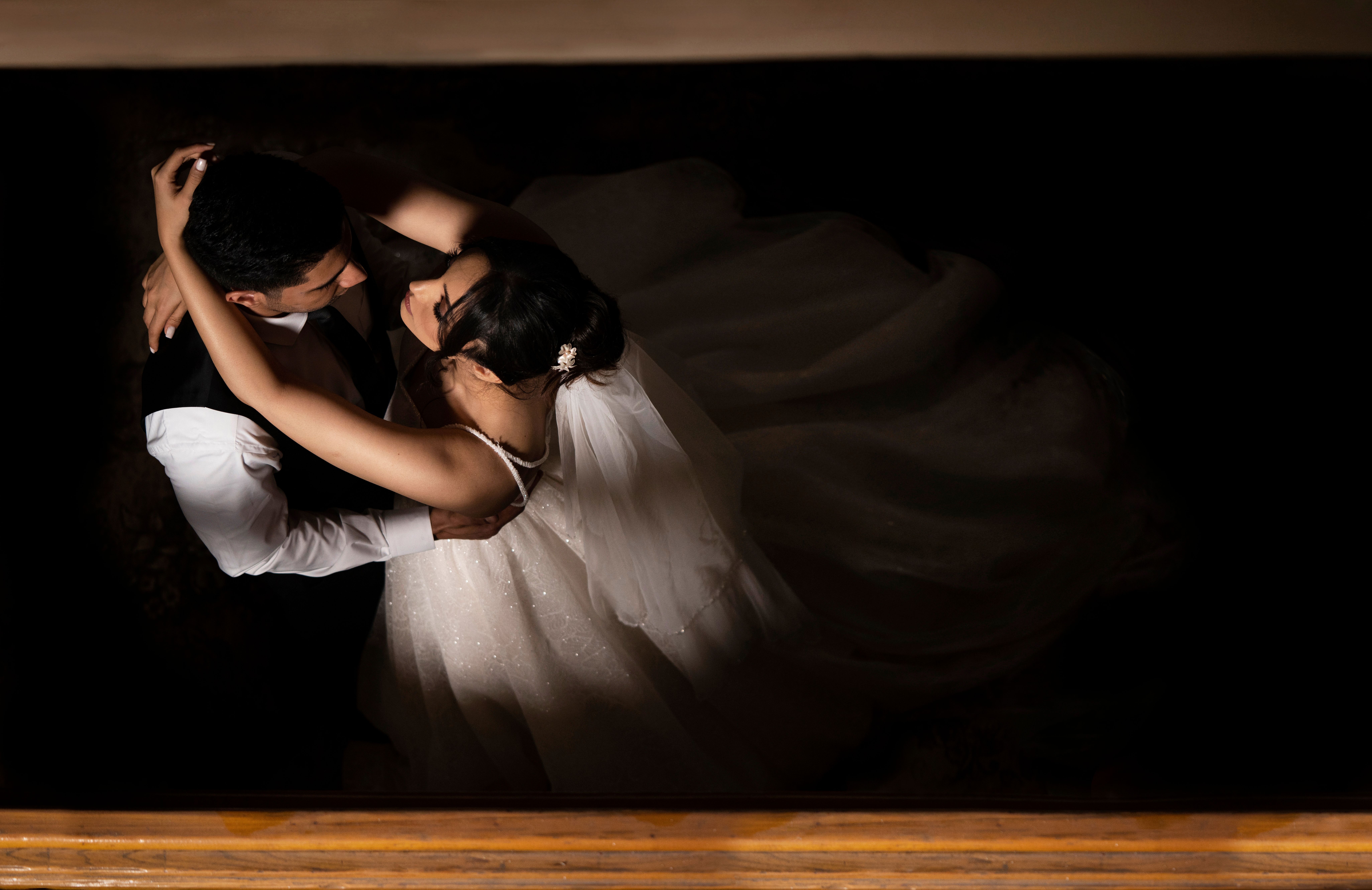 Marassi wedding entertainment — A top-down view of a bride and groom embracing during a dance, capturing the essence of love 