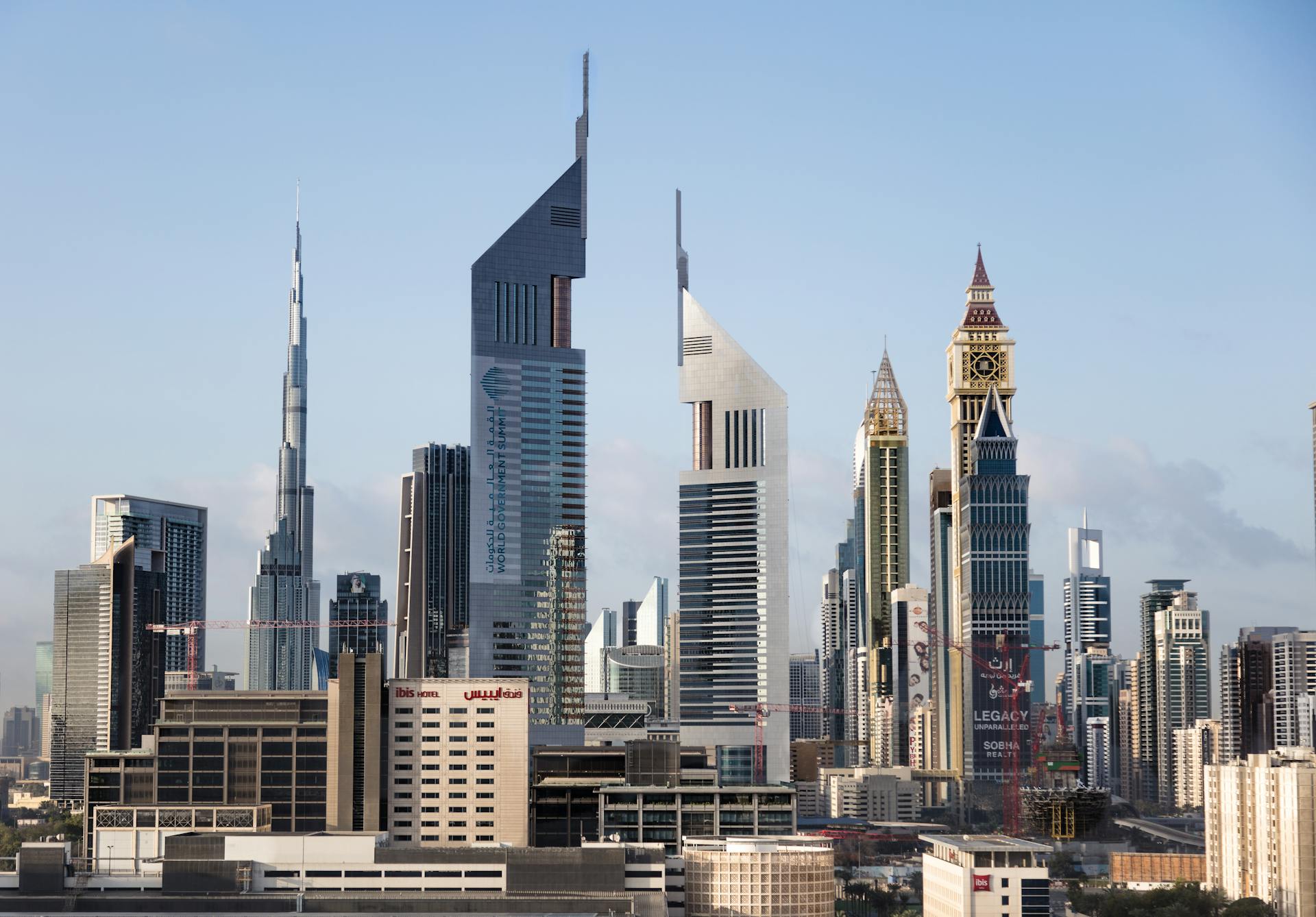 Stunning view of Dubai's skyline featuring the Emirates Office Tower and Burj Khalifa under a clear blue sky.