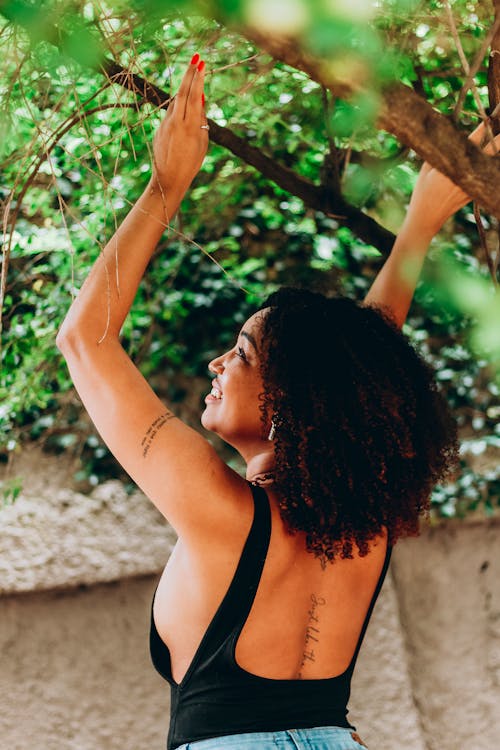 Back View of Posing Woman with Arms Raised