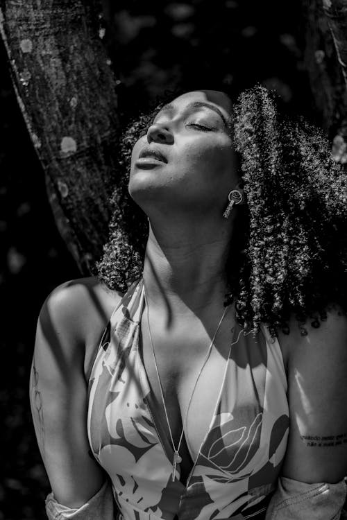 Woman Posing with Eyes Closed in Black and White