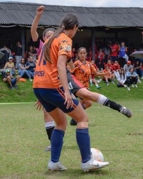 Dynamic action shot of a women's soccer game with players competing on the field.