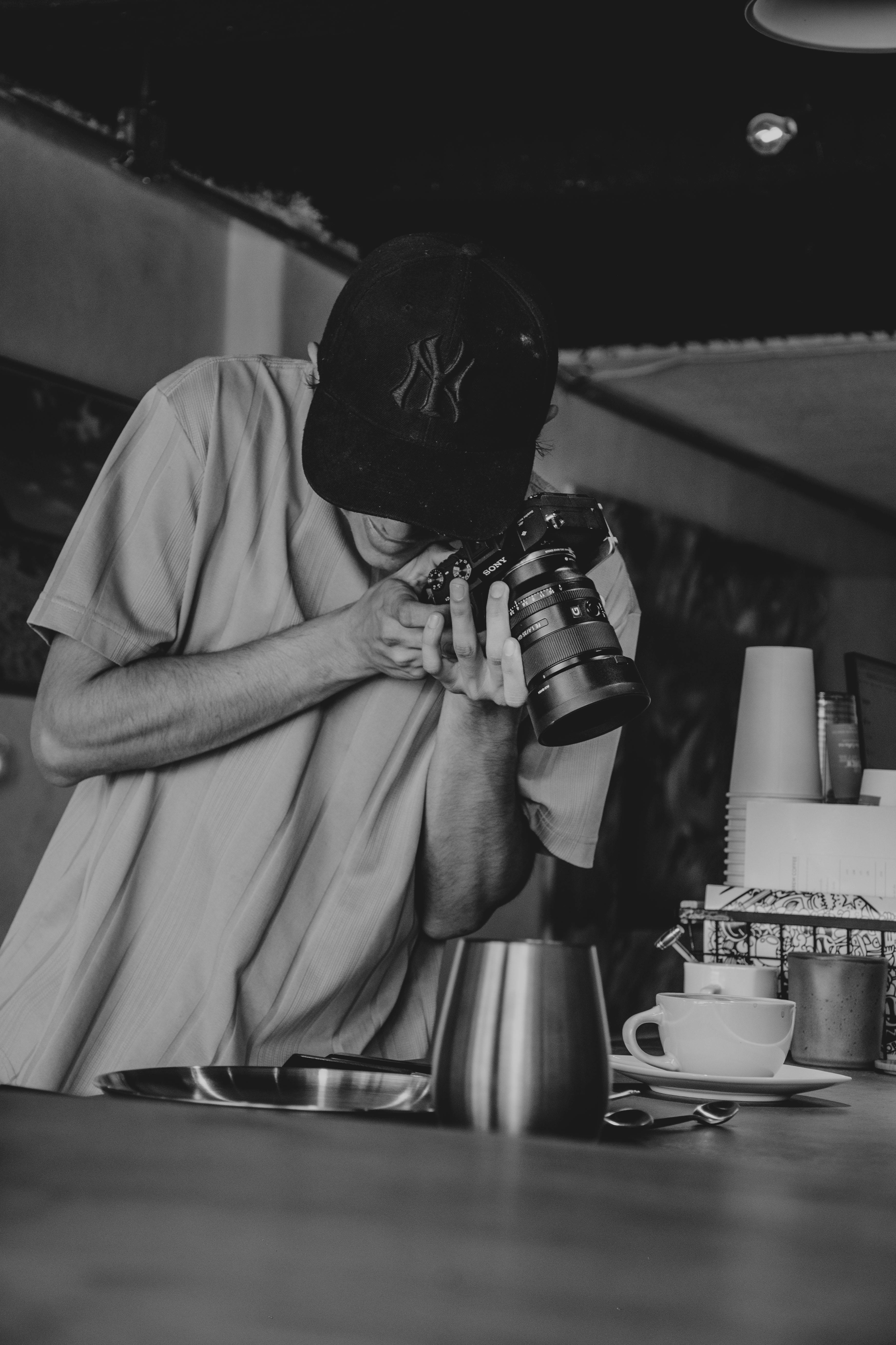 Photographer capturing the café experience in a stylish black and white setting.