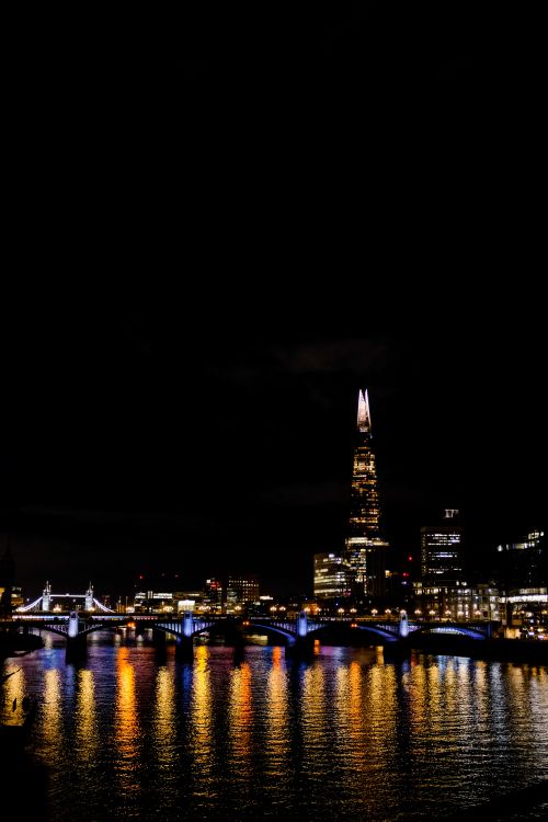 Free Captivating London cityscape at night featuring illuminated skyscrapers and bridges over the Thames. Stock Photo