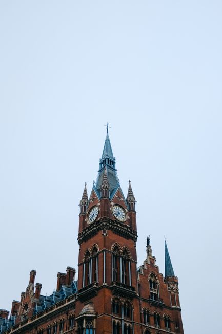 Low angle view of a historic tower in London with clear blue sky background.