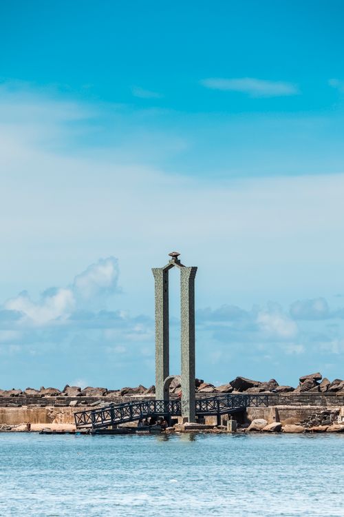 Free Iconic unfinished bridge sculpture in Recife, Brazil, with ocean backdrop. Stock Photo