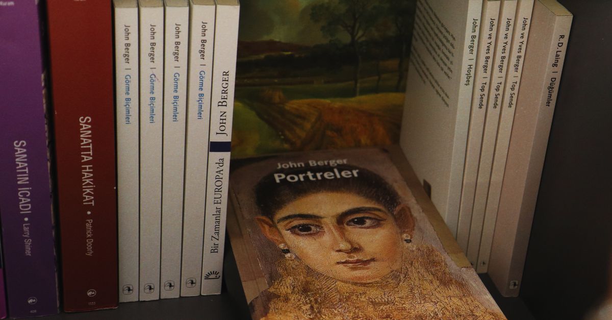 Bookshelves with a selection of John Berger's books featuring an artistic portrait cover.