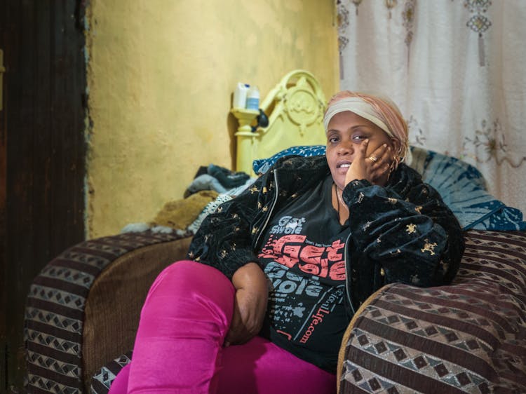 Woman Sitting In An Armchair At Home 