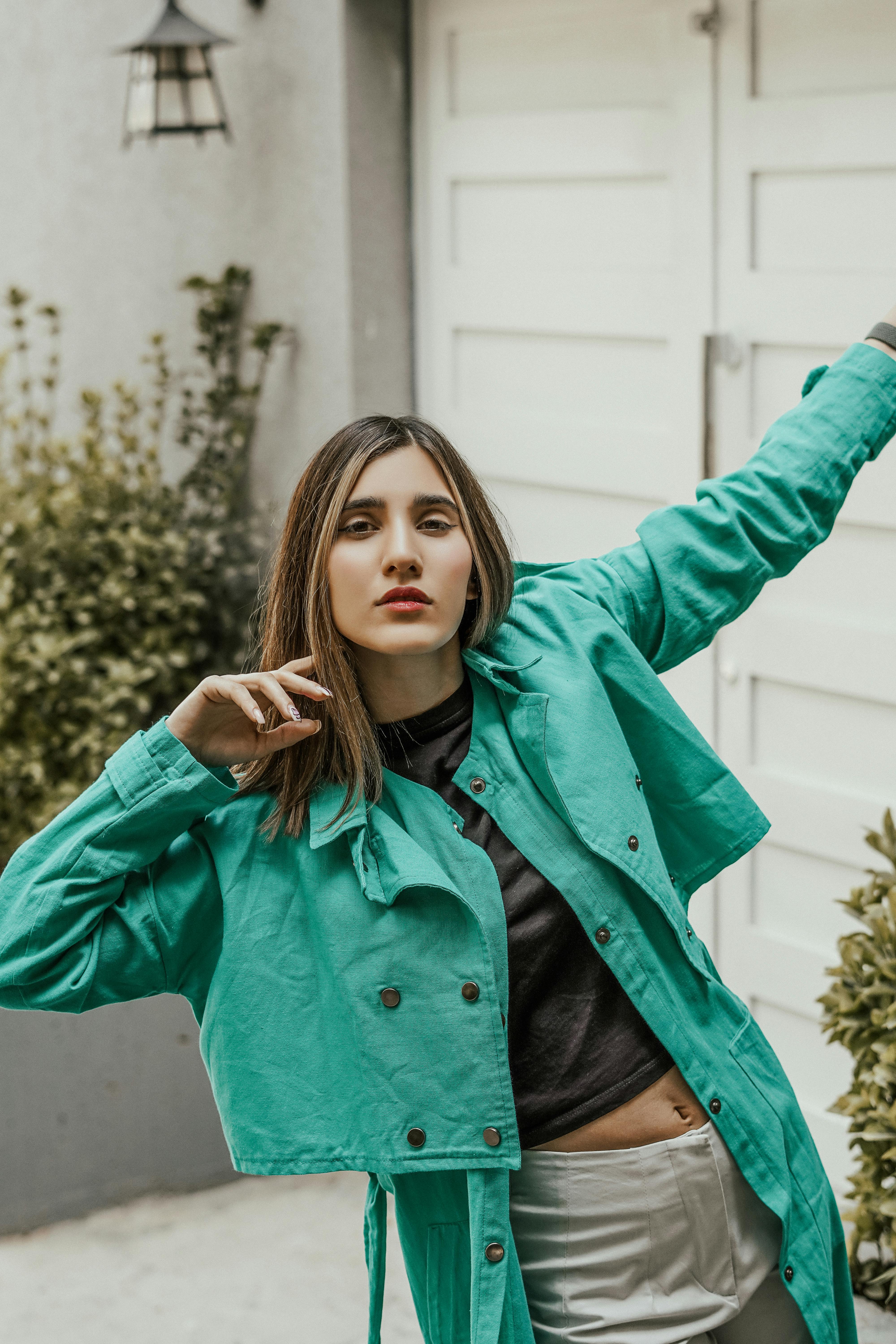 Free A woman in a green jacket posing for a photo Stock Photo