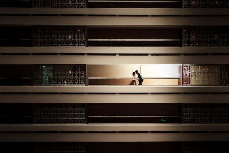 Couple Kissing In Room Behind Bars