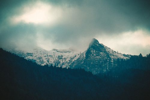 Free Dramatic winter scene of snow-covered mountains and dark clouds. Stock Photo